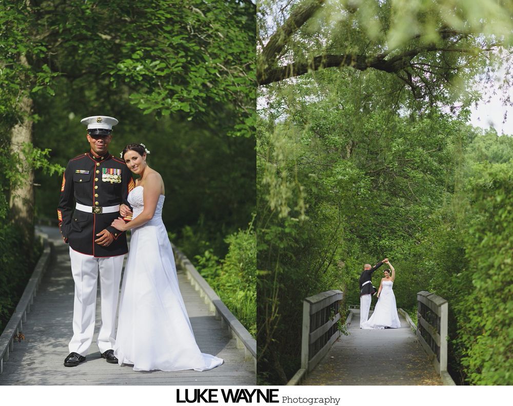 Wedding couple, Marine in uniform, on wooden bridge surrounded by lush greenery, posing and dancing.
