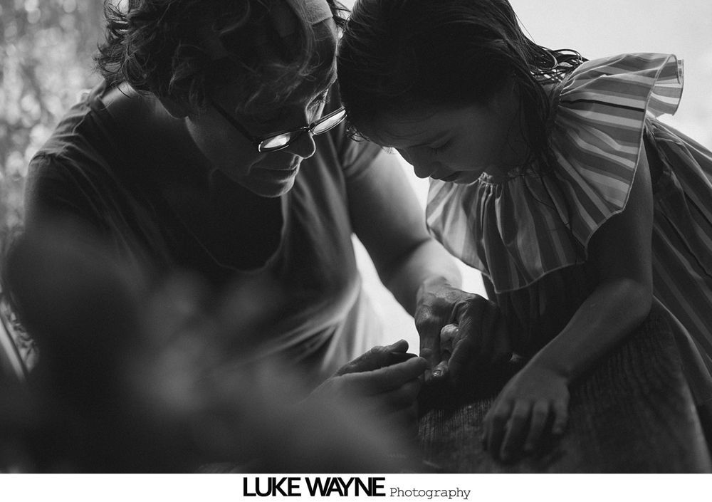 Three floral arrangements: one in a mason jar, one bouquet, one boutonniere; various light pink and white flowers.