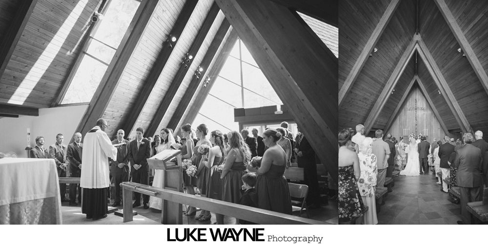 Wedding party posing on a road, with the bride and groom at the center. Some are smiling, others are making silly faces.