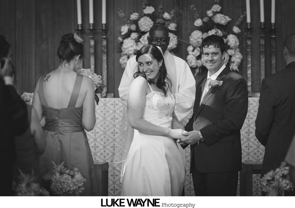 Three couples posing outdoors; men in suits, women in dresses; smiling, natural lighting.