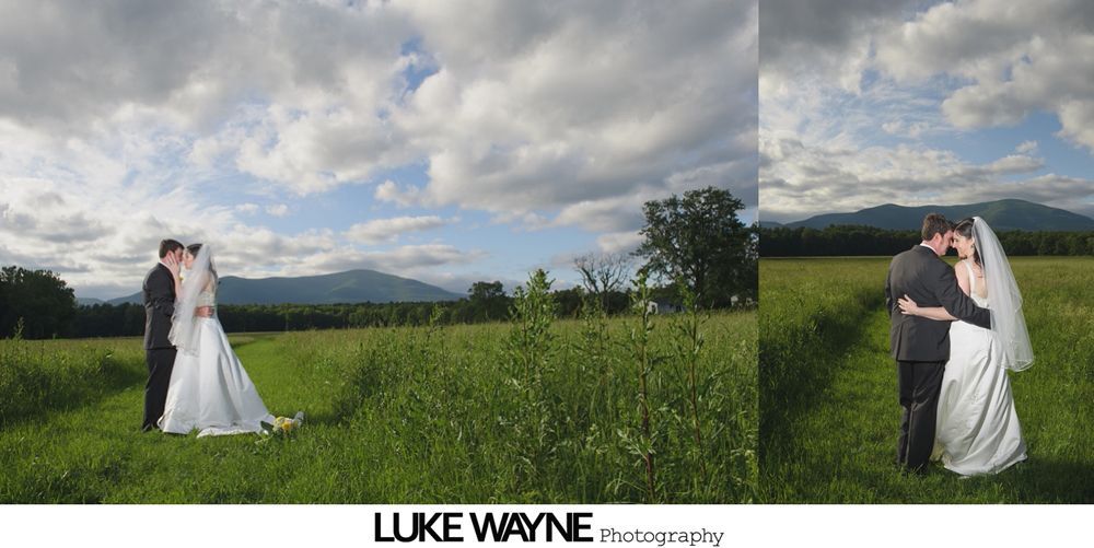 Group photo at a wedding reception. Bride and groom centered, surrounded by guests in formal attire.