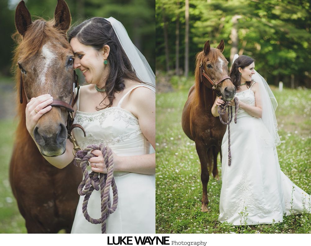 Group photo at a wedding reception. Bride and groom centered, surrounded by guests in formal attire.