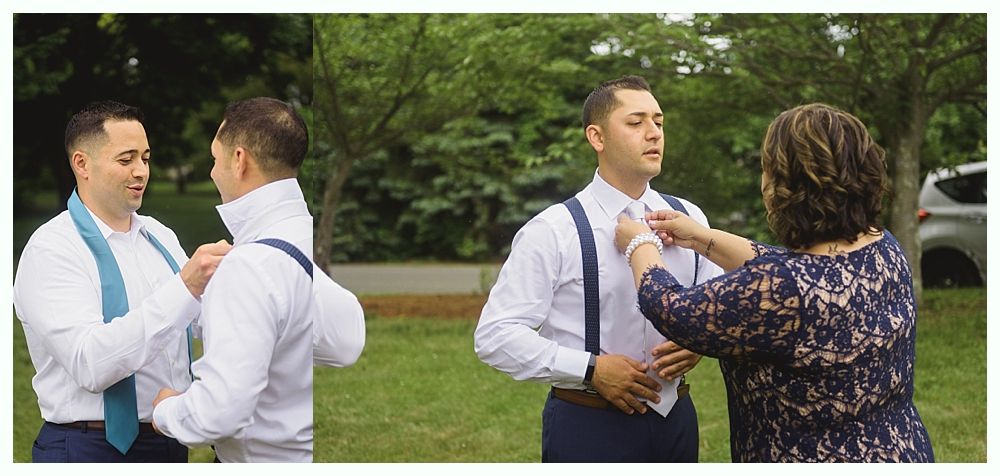 Wedding party walking in a garden. Bride and groom holding hands, smiling. Bridesmaids in navy dresses, groomsmen in gray suits.