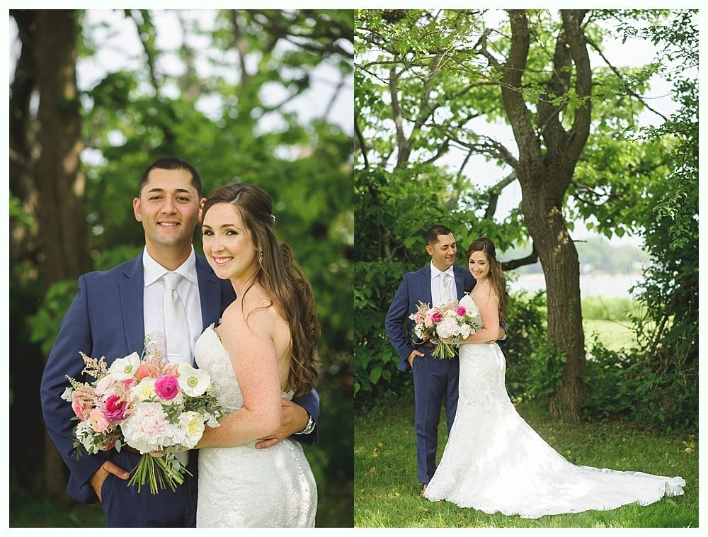 Groomsmen in gray vests and blue ties pose in front of green foliage. One younger boy wears a bow tie.