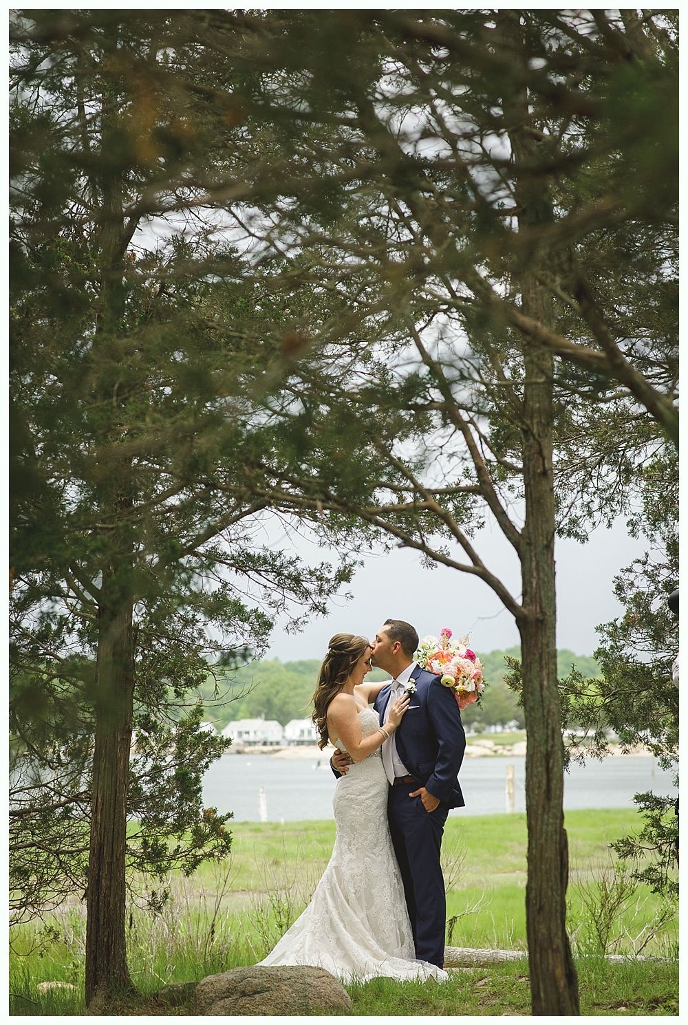 Rustic wedding venue with string lights, chandelier, and floral arch over doors.