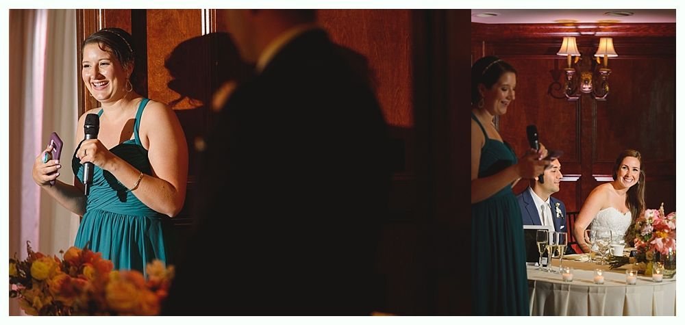Bride and groom embrace in front of a red building with stairs. Cloudy sky.
