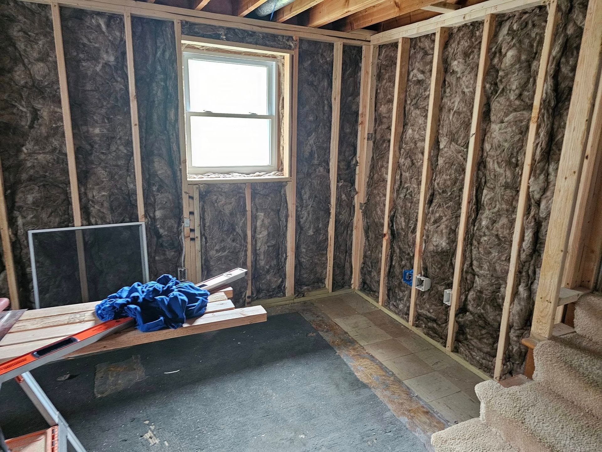 A room with a window and a lot of insulation on the walls.