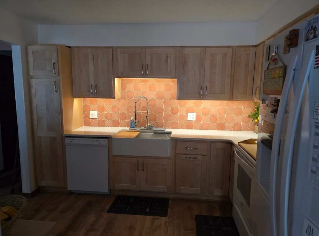 A kitchen with wooden cabinets and a white refrigerator