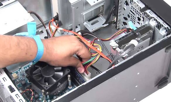 A person is working on the inside of a computer.