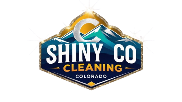 Logo for Shiny Co Cleaning in Colorado, featuring a blue and white mountain scene within a gold and blue hexagon, and the letter 