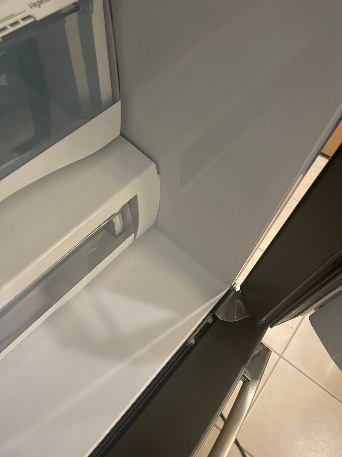 A close up of the inside of a refrigerator with the door open.