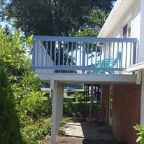 There is a balcony on the side of a house.