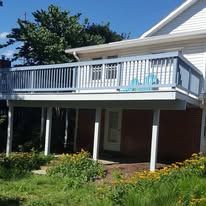 A house with a large balcony on the back of it.