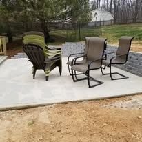 A group of chairs sitting on top of a concrete patio.