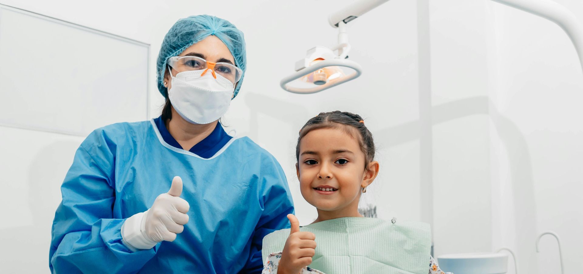 Dentist and child smiling at dental office 