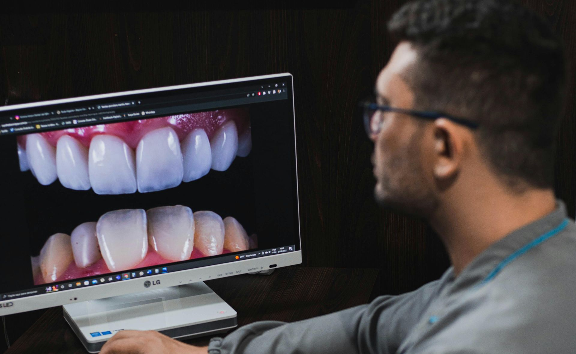 dentist looking at teeth on a computer