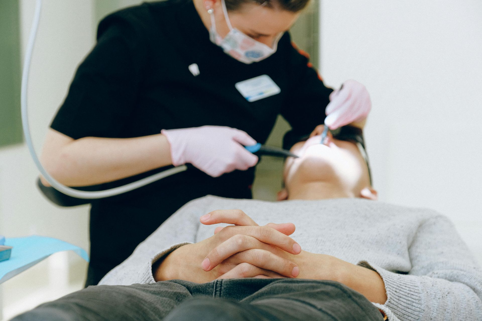 dentist performing a dental cleaning on a patient