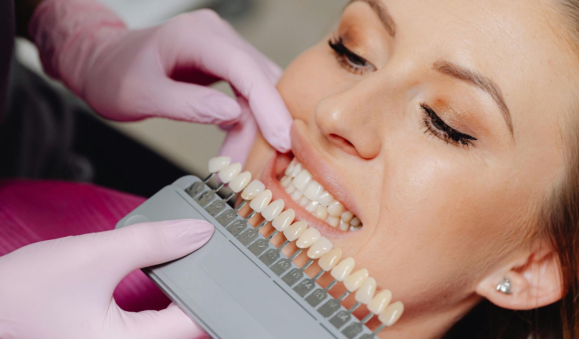 Woman at the dentist looking at veneers match