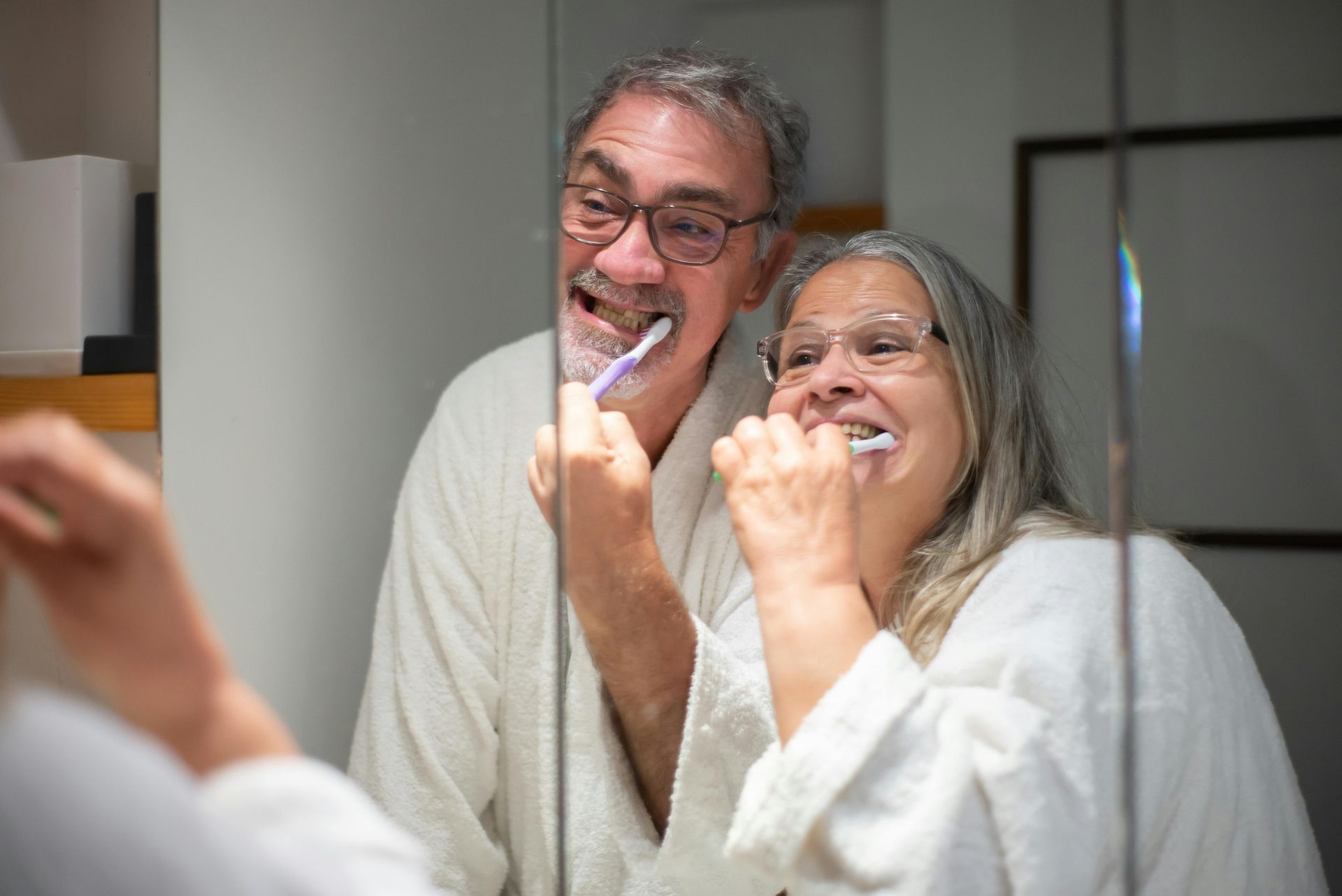 Couple brushing their teeth