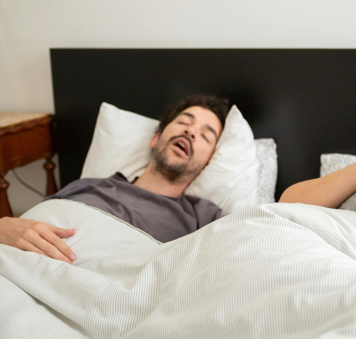 man sleeping and breathing with his mouth open