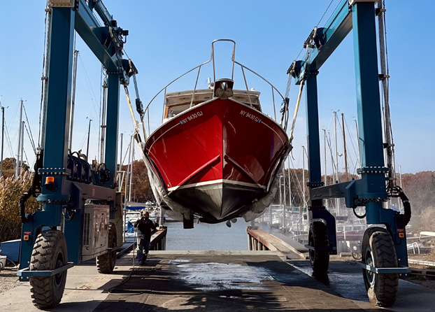 A dock filled with boats and a rainbow in the sky