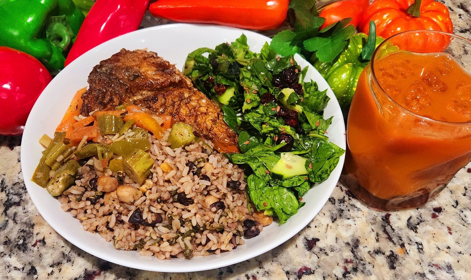 A close up of a plate of food on a table with the ocean in the background.