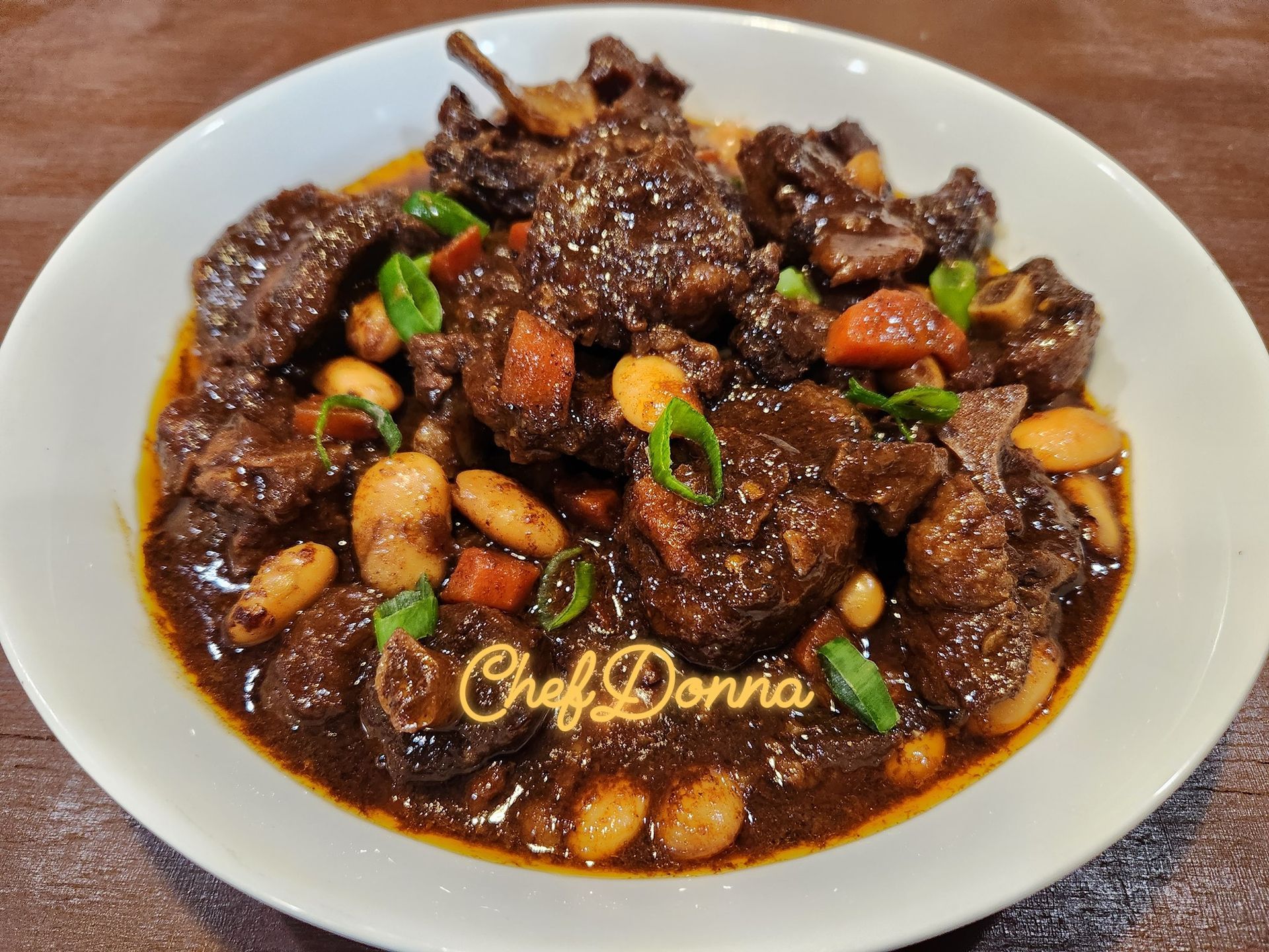 A group of people are sitting at a table with plates of food.