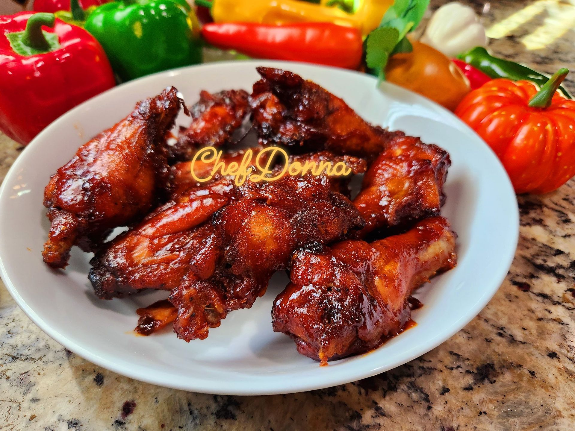 A plate of chicken wings with chef donna written on it