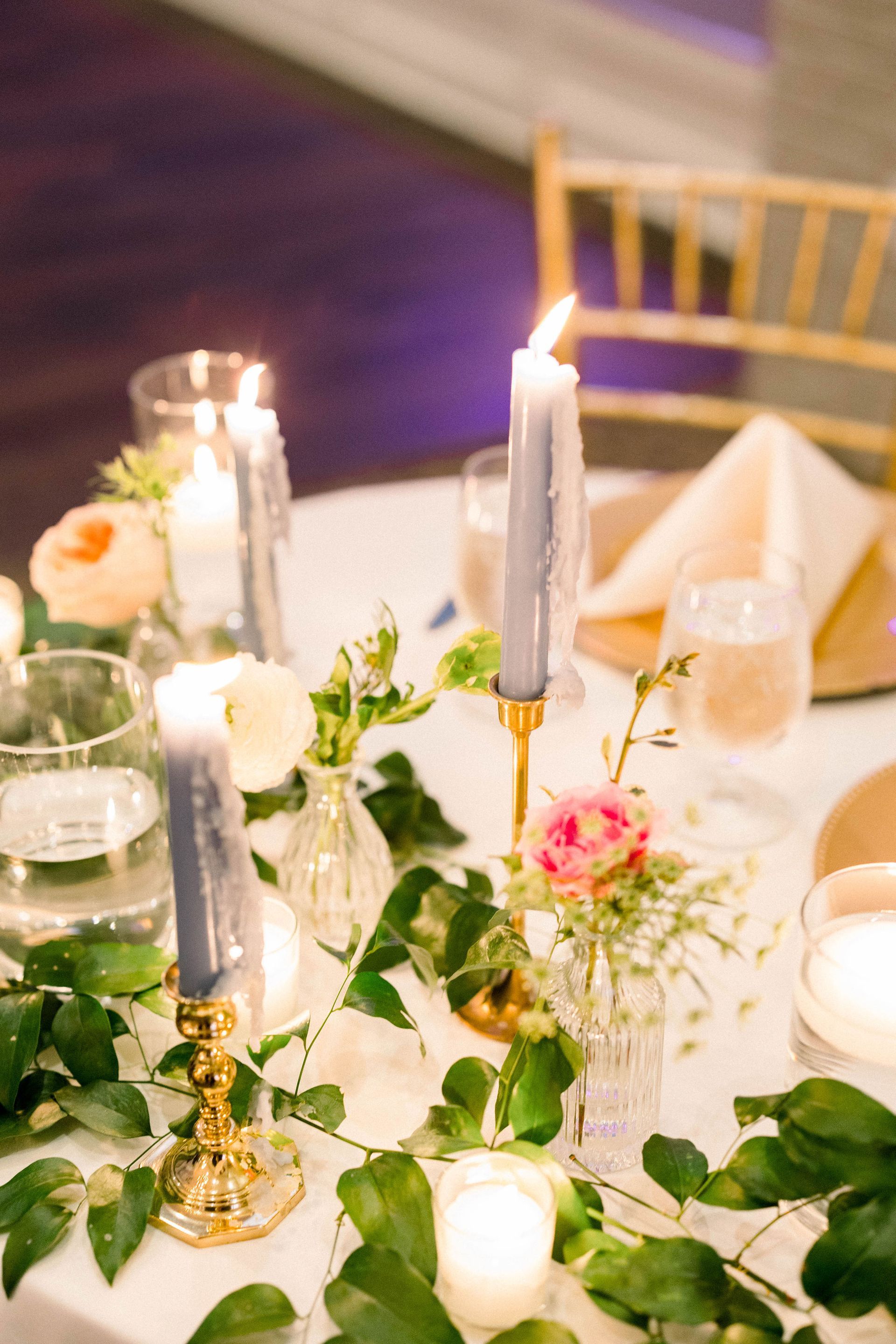 blue candle pink flower bud vase wedding table