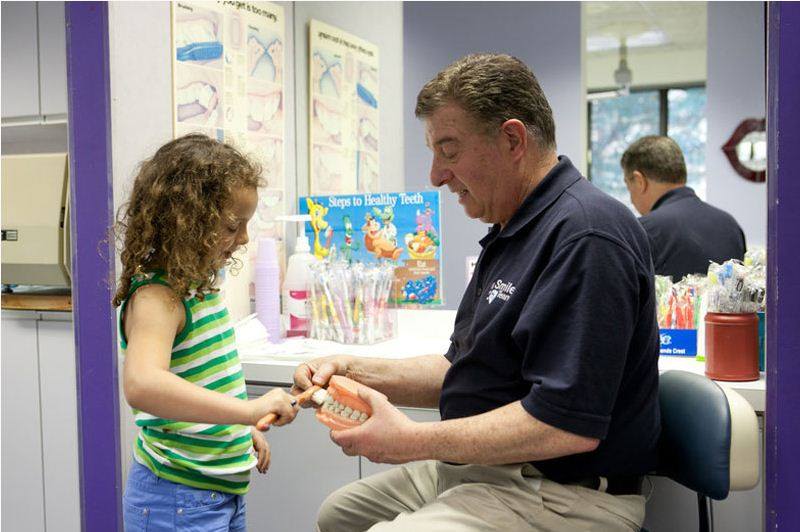 Dr. steven talking to a kid — kids dentist in Manalapan, NJ