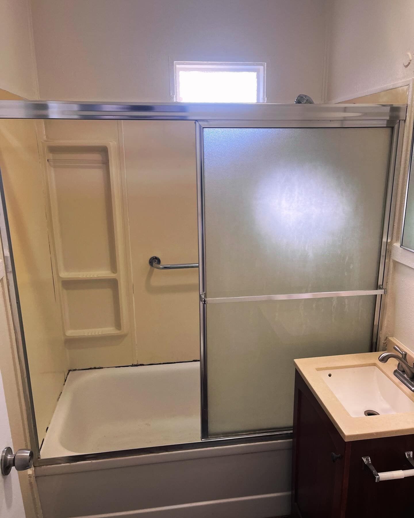 A bathroom with a bathtub , sink , and shower stall.