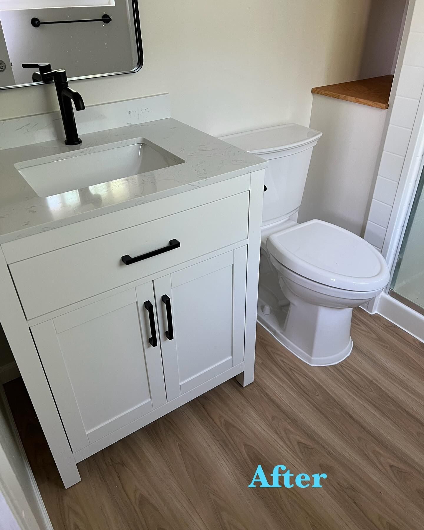 A bathroom with a sink , toilet and mirror.