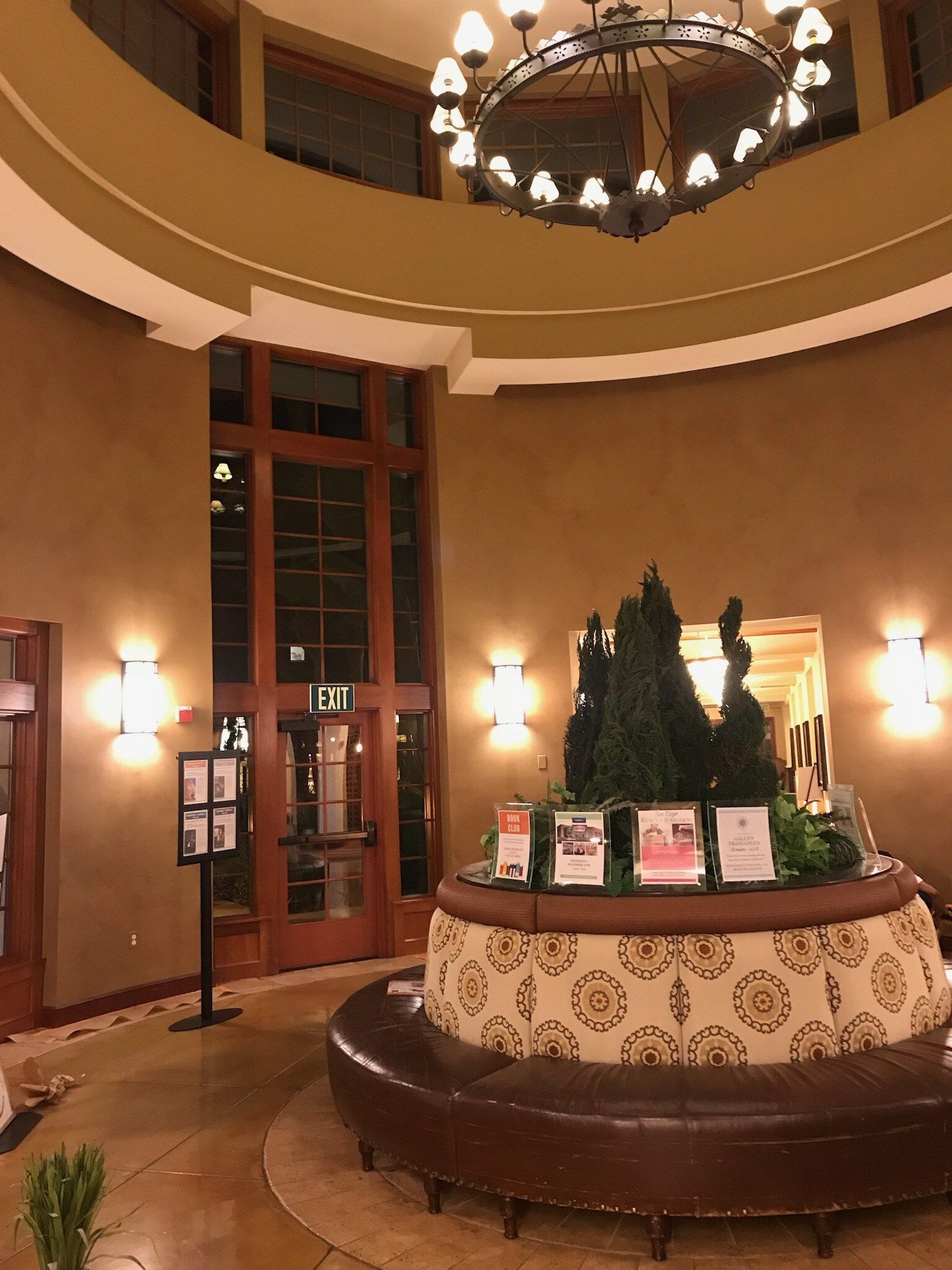 A large room with a chandelier and a sign that says exit