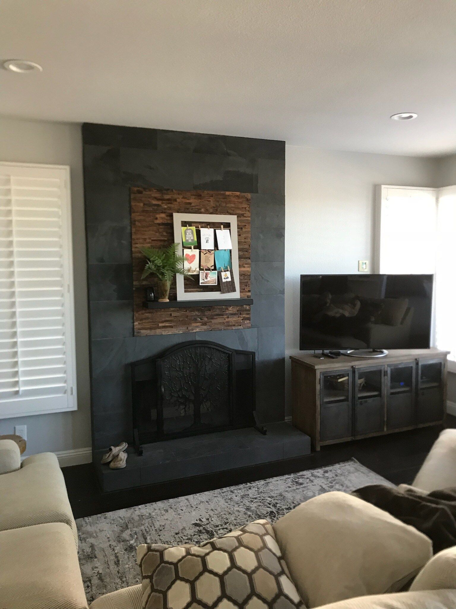 A living room with a fireplace and a flat screen tv.