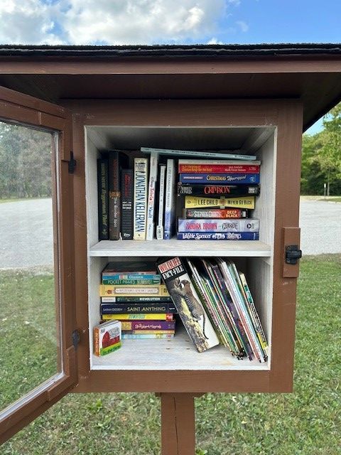 A small bookcase filled with books including a book called encyclopedia