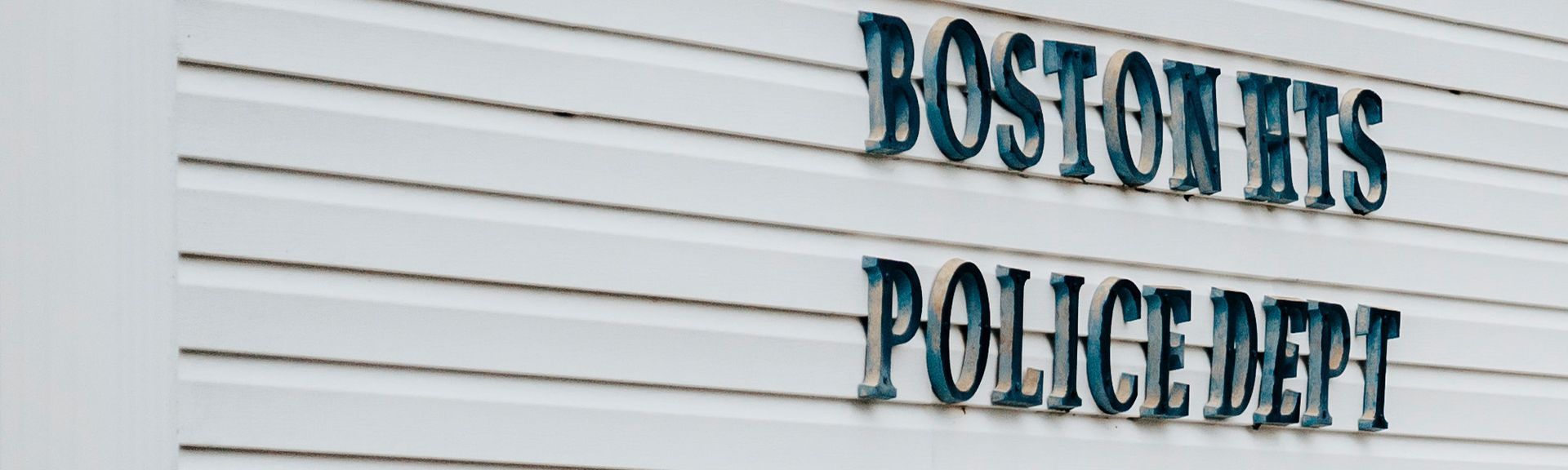 A boston heights police department sign on a white building