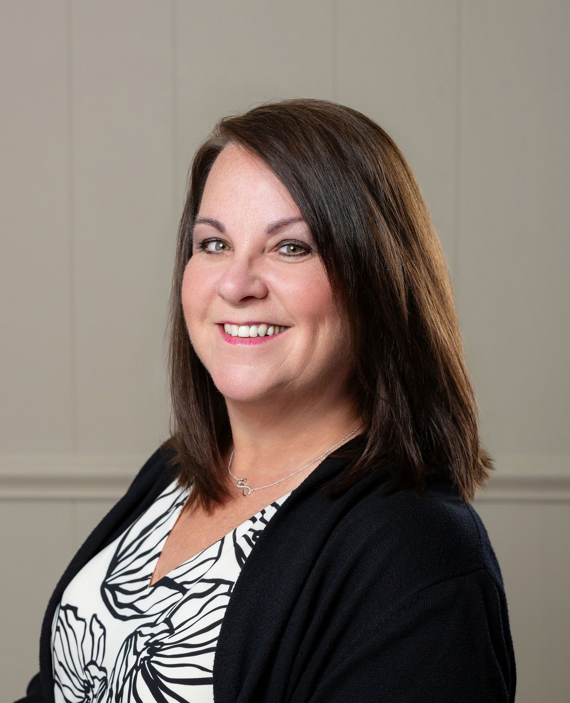 A silhouette of a woman without a face on a gray background.