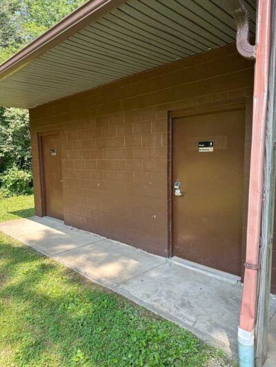 There are two doors on the side of a building.