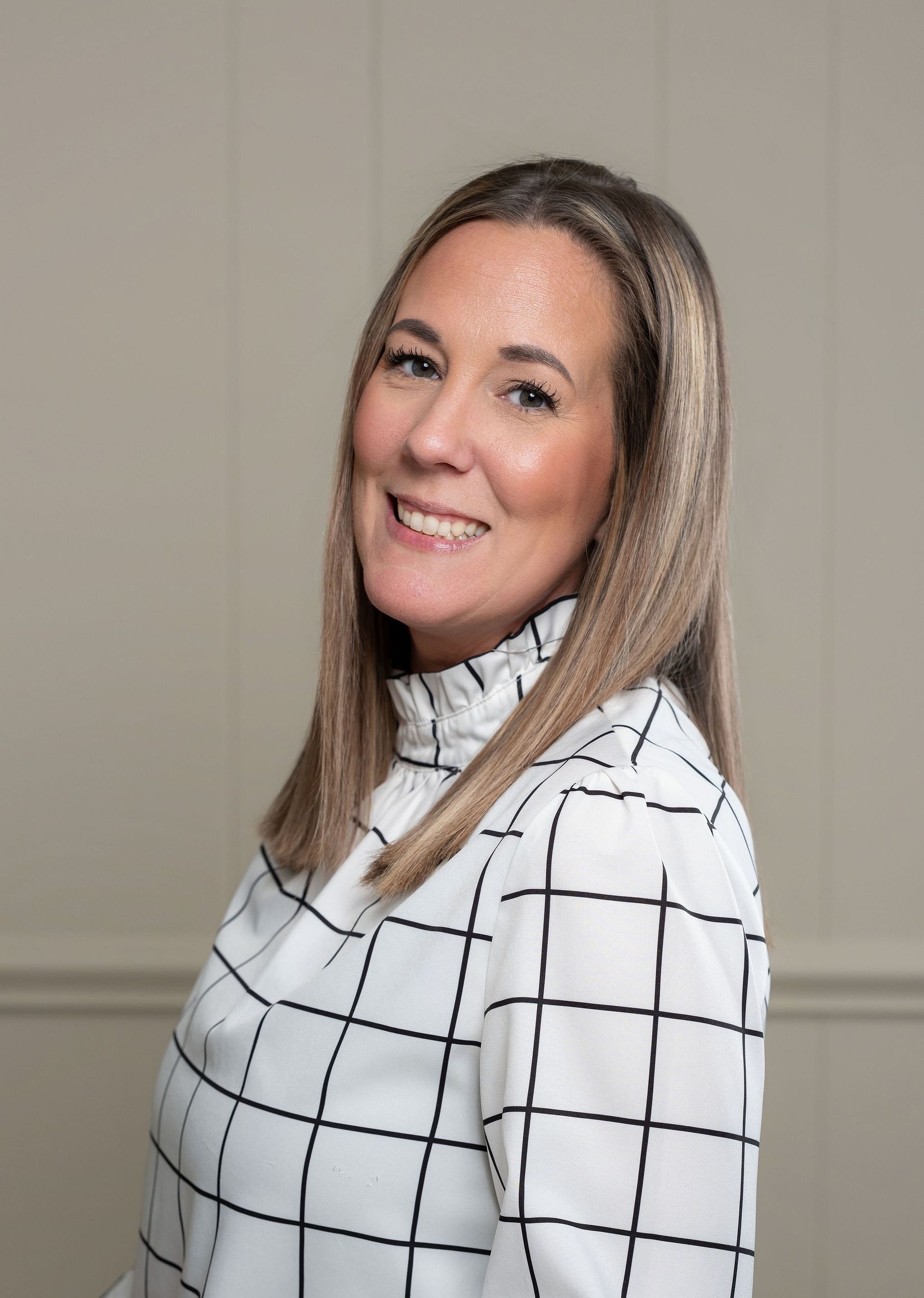 A silhouette of a woman without a face on a gray background.