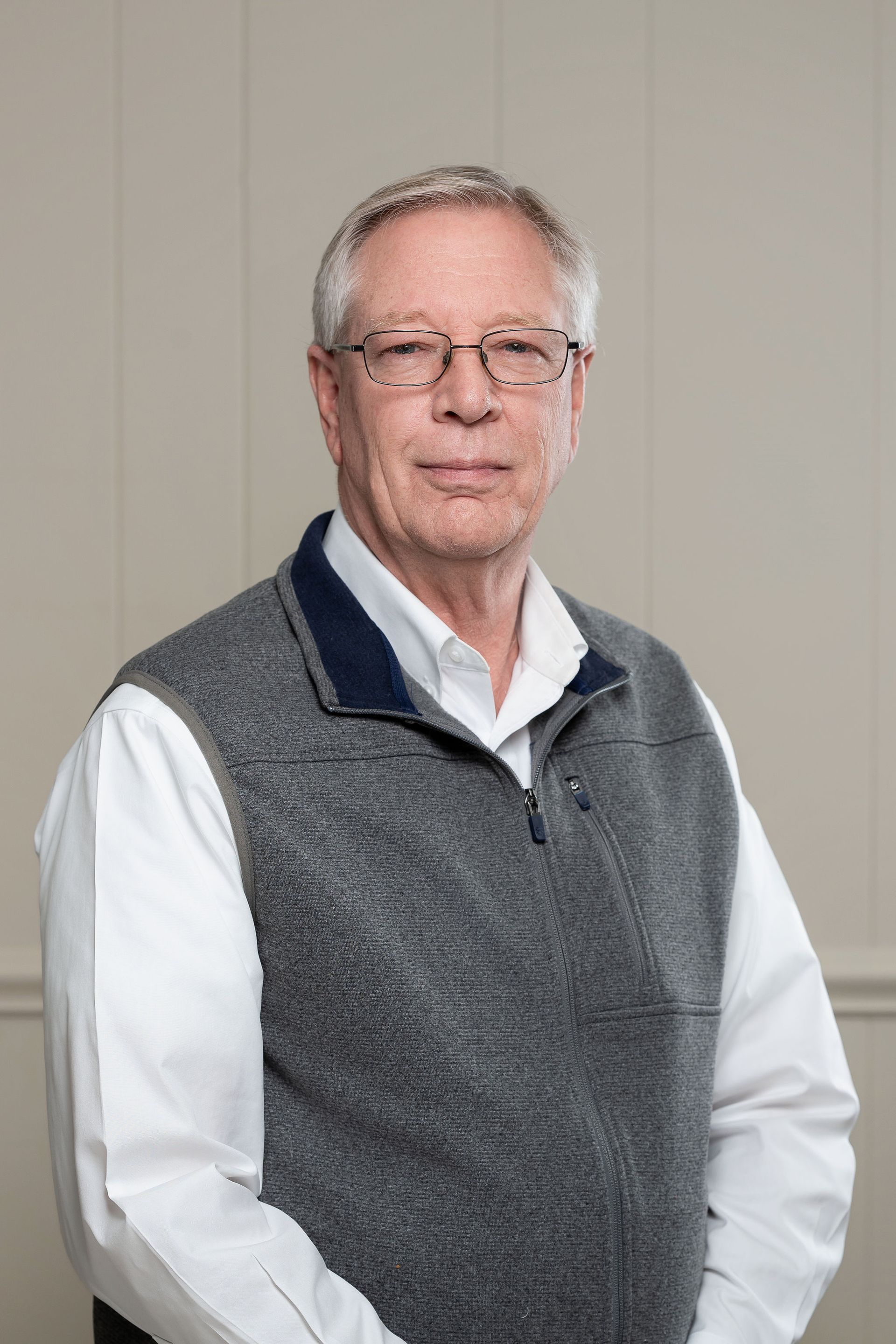 A silhouette of a man without a face on a gray background.
