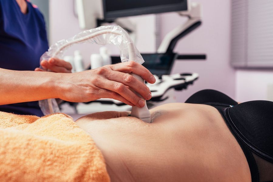 A woman is getting an ultrasound of her stomach.