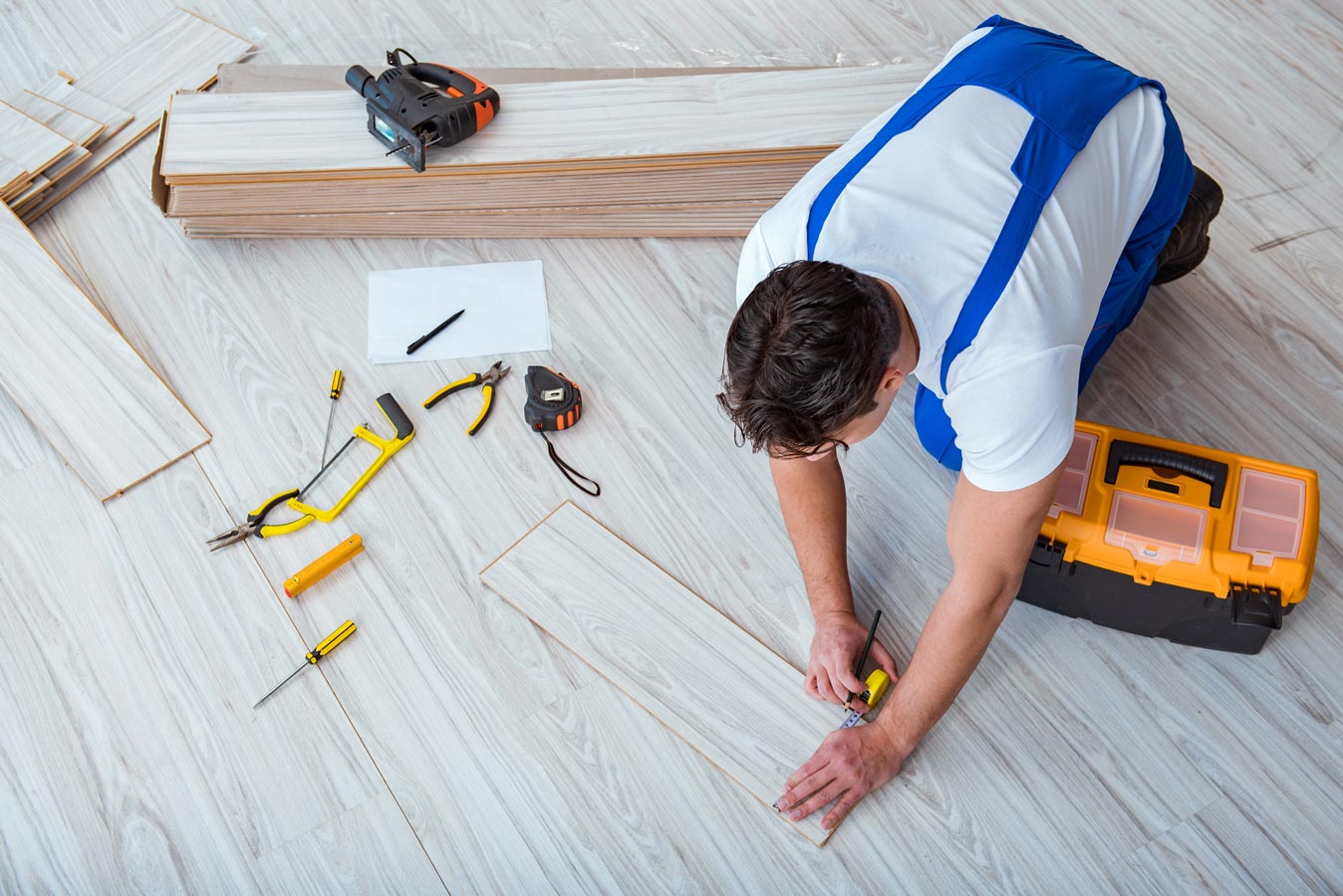 Man Installing Floor —  Floor Coverings In Goonellabah, NSW