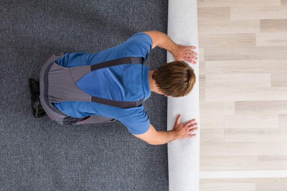 Man Laying carpet  —  Floor Coverings In Goonellabah, NSW