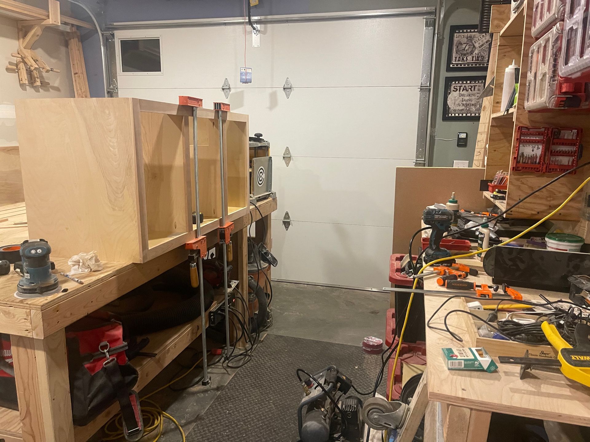 A garage filled with lots of tools and a garage door.