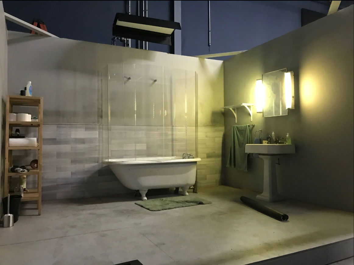 A bathroom with a bathtub a sink and a mirror