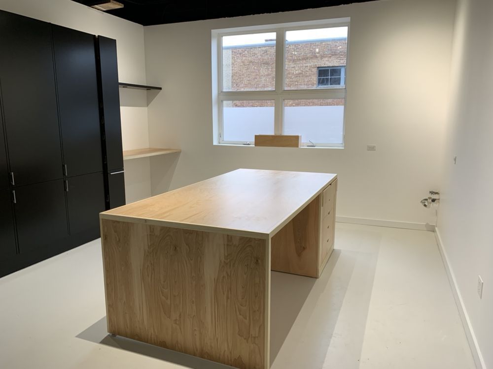 There is a large wooden table in the middle of the room.