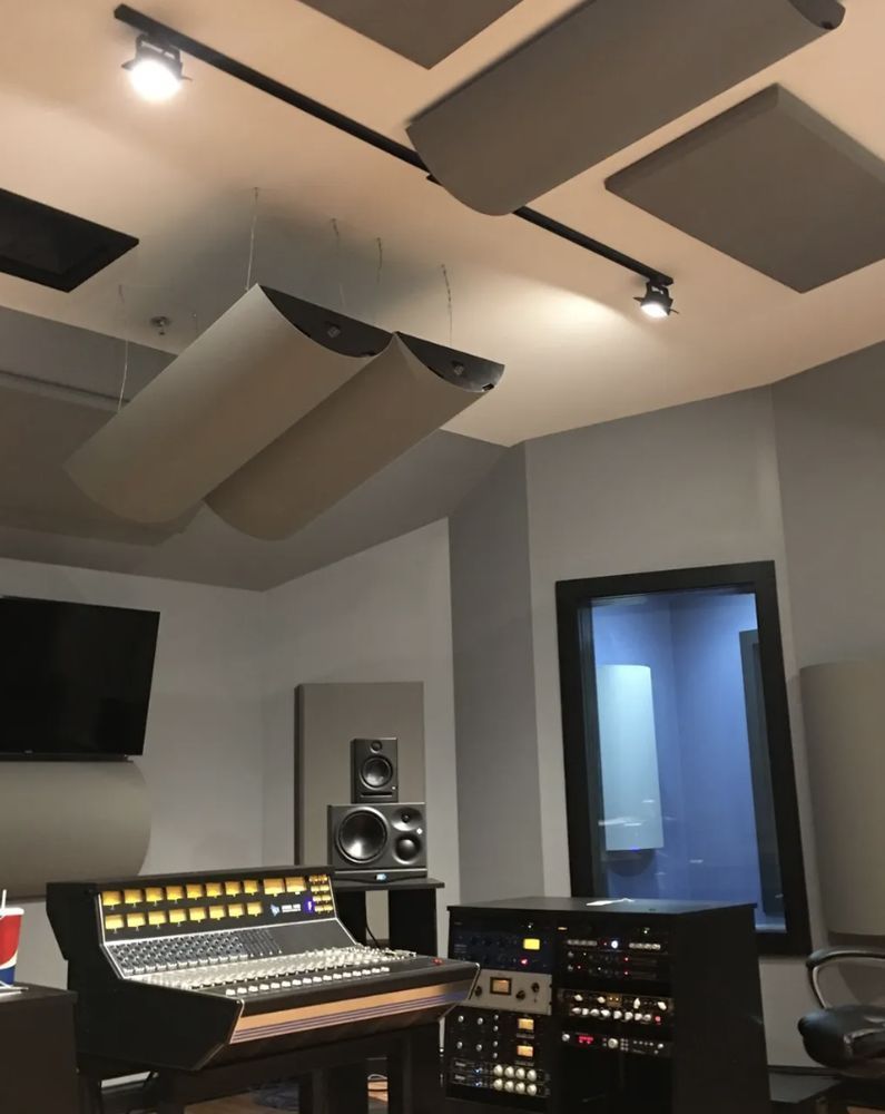 A recording studio with a pepsi cup on the table