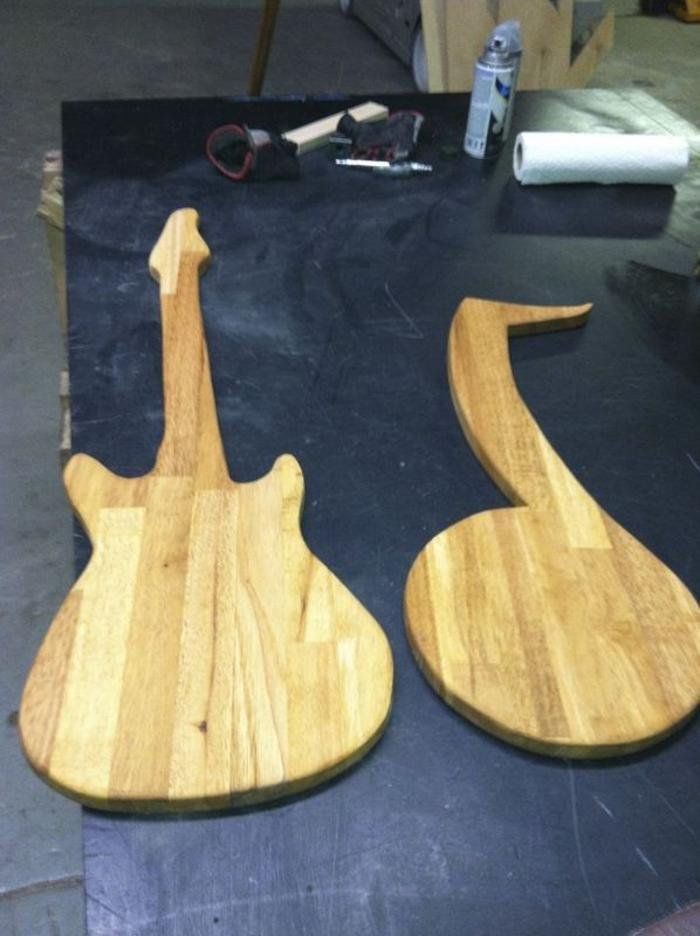 Two wooden guitars are sitting on a table
