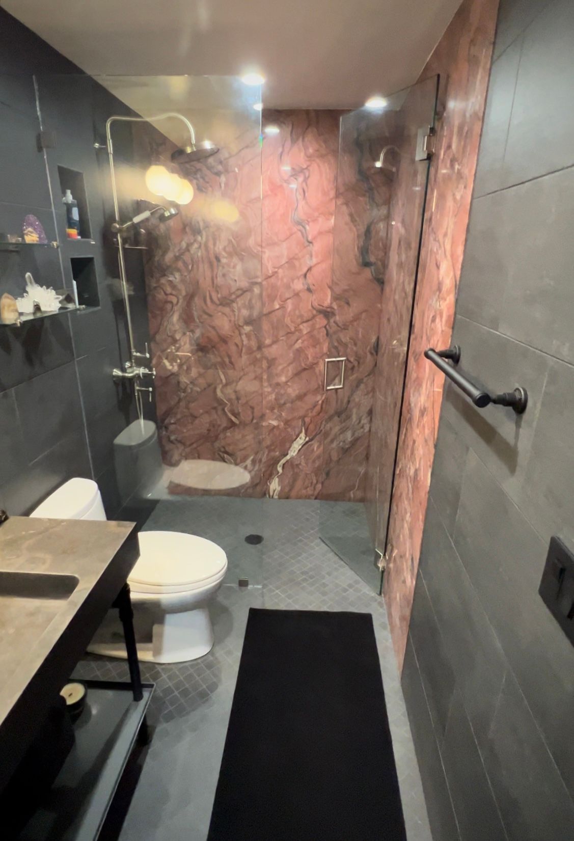 A bathroom with a toilet , sink , and shower.