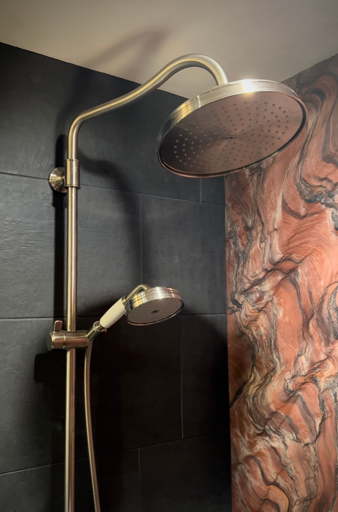 A close up of a shower head in a bathroom.